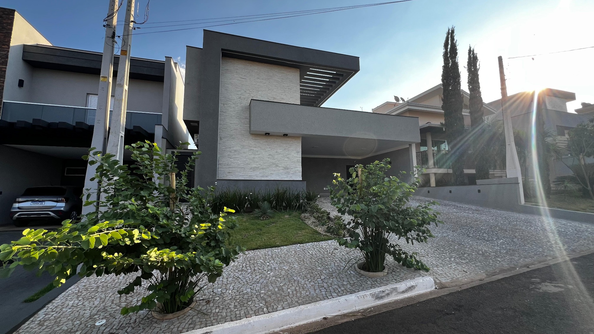 Fachada residencial moderna com paisagismo frontal